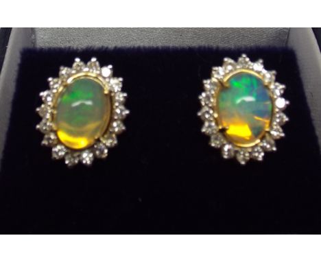 Pair of oval opal and diamond cluster ear studs, 1.4 cms high