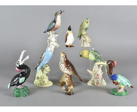 A Beswick model of a parrot, model 930, together with a Beswick Budgie 1217, two 19th Century Naples porcelan bird figures, a