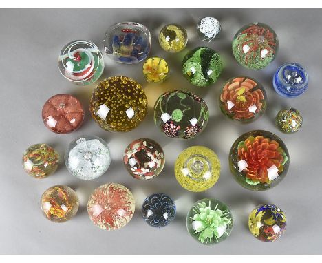 A collection of glass coloured paperweights, all having internal bubble and floral decorationChips to the base of three. One 