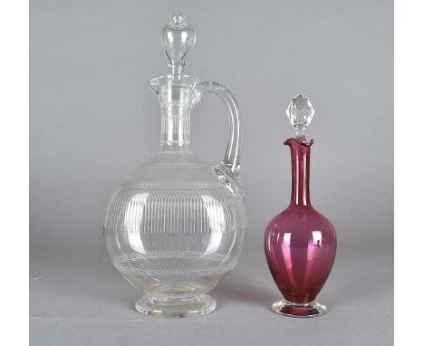 An Edwardian glass wine carafe, with an engraved body of scrolls, beads and festoons and stopper, together with an ovoid cran