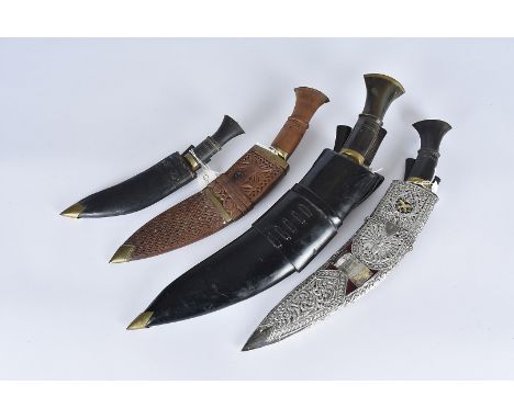A group of four Kukri knives, all various sizes, one having a decoration white metal case, with applied presentation plaque, 