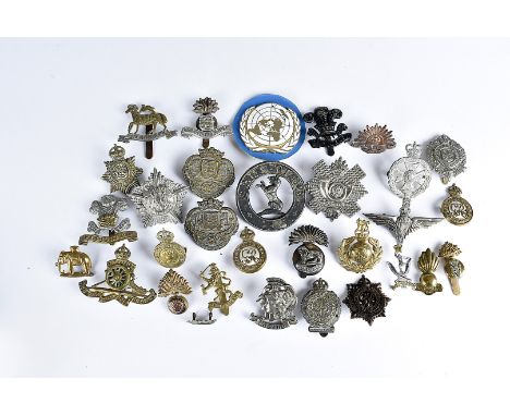 An assortment of WWI and later cap badges, to include the Grenadier Guards Machine Gun Regt 1917, Highland Light Infantry Ass