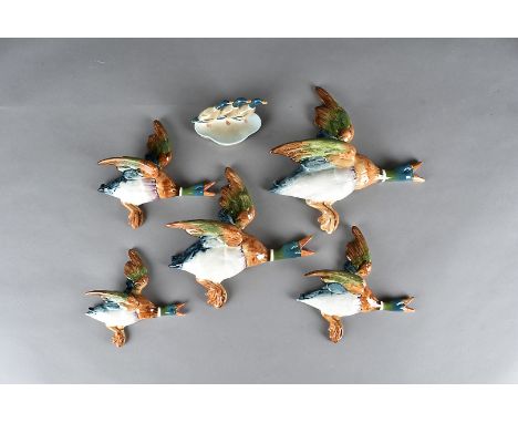 A set of five wall mounted flying Beswick ducks, model no 596 together with a Beswick duck pin tray and a Royal Worcester can