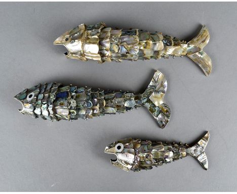 A set of three graduated mother of pearl and abalone articulated fish, bottle openers, largest 20 cm, smallest 13 cm 