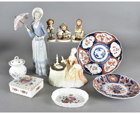 A collection of modern 20th Century ceramics, including a Lladro figure of an elegant lady with parasol, five Hummel figures,