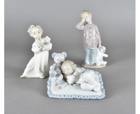 A Lladro figure of sleeping girl with her Teddy Bear, and two Nao figures of childrenBoth have light scuffing and rubbing to 