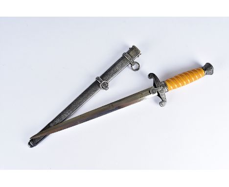 A Third Reich Heer dress dagger, having eagle and Swastika to the hand guard, with unnamed blade, in white metal scabbard, po