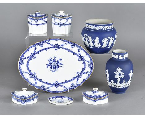 A Wedgwood blue and white dressing table set, the oval shaped jars and covers upon an oval tray with a small matching pin tra