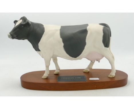 Beswick Connoisseur Friesian cow model no. A2607 on a wooden plinth. 