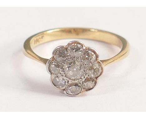 18ct yellow gold, 9 diamond set daisy ring. Centre stone measures 3.5mm appx.  Size M, weight 2.8g. Diamonds bright but some 