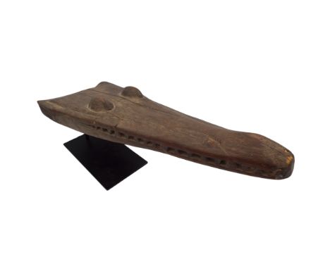 A Sepik river, Papua New Guinea wood carved canoe prom raised on metal stand, height including 21cm.