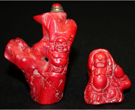 TWO CHINESE RED CORAL SNUFF BOTTLES & STOPPERS, each carved in the form of Budai and a tree trunk, 3in & 1.6in high. (2) 