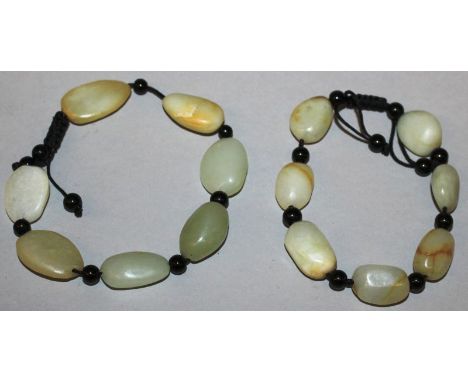 A PAIR OF CHINESE CELADON JADE-LIKE BRACELETS. 