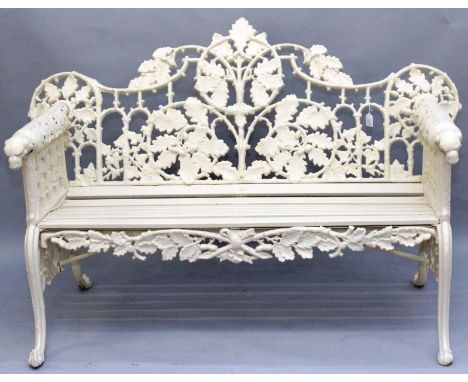 A GOOD COALBROOKDALE DESIGN CAST IRON CREAM PAINTED GARDEN BENCH, pierced acorn and oak leaf design backs, slatted wooden sea