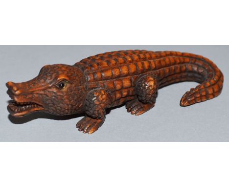 A CARVED WOOD NETSUKE, an alligator Signed. 