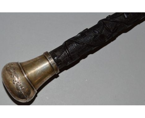 A GOOD EARLY 19TH CENTURY IRISH WALKING STICK carved with a harp and clover leafs with silver handle Dublin 1825. 38.5ins lon