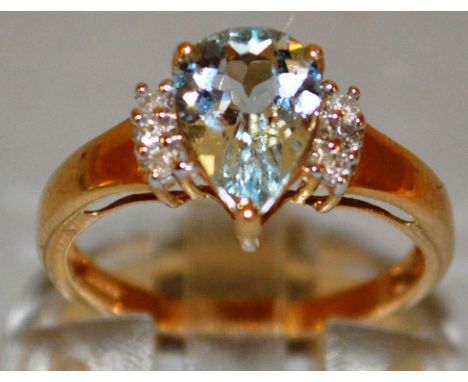 A GOOD LIGHT BLUE TEARDROP AND DIAMOND RING set in 9ct gold. 