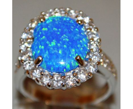 AN OPAL AND BRILLIANT OVAL CLUSTER RING. 