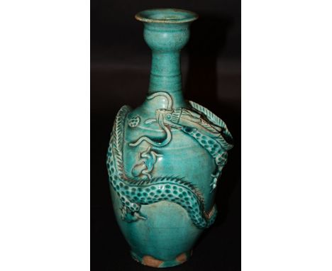 AN ORIENTAL TURQUOISE-GLAZED CERAMIC VASE, the sides moulded with a sinuous dragon,10.1in high. 