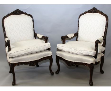 A PAIR OF FRENCH ARMCHAIRS with carved beech wood frames and cream classical print upholstery. 