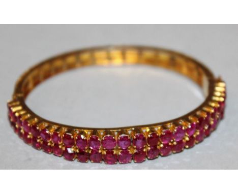 A SUPERB DOUBLE ROW RUBY AND GOLD BRACELET set with FIFTY TWO RUBIES. 