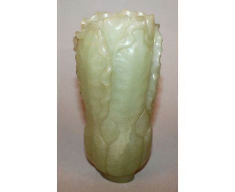 A CHINESE CELADON GREEN JADE-LIKE LOTUS VASE, the sides naturalistically formed from overlapping leaves, 6.3in high. 