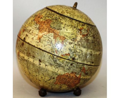 A 19TH CENTURY TIN WORLD GLOBE TEA CADDY on three bun feet 7ins diameter. 