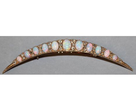 A GOOD LARGE OPAL AND DIAMOND CRESCENT BROOCH set with eleven opals interspersed with small diamonds. 