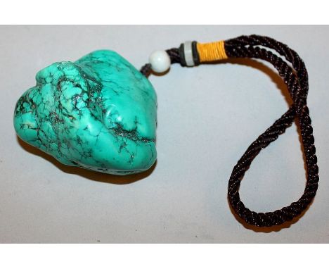 A CHINESE TURQUOISE-LIKE PENDANT, of boulder form, with attached tassel, the pendant 2.4in wide & 2.1in high. 