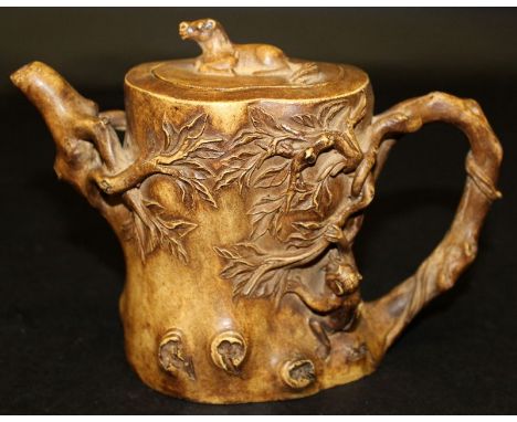 A CHINESE YIXING CERAMIC TEAPOT & COVER, modelled in the form of a gnarled tree stump upon which a monkey clambers, the base 