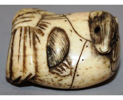 A JAPANESE NETSUKE, a sleeping rat 1.5ins. 