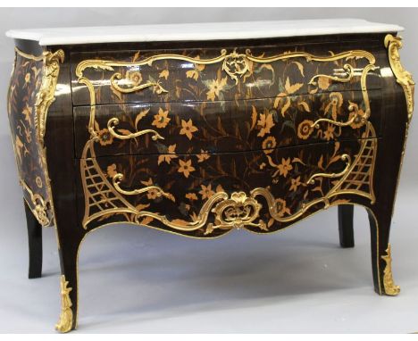 A LOUIS XVI DESIGN COMMODE, with marble top, floral marquetry inlay and ormolu mounts, three long drawers, on cabriole legs. 