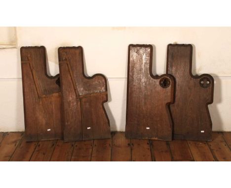 Four gothic oak church pew ends, each having quatrefoil carved decoration, reputedly from Dedham church