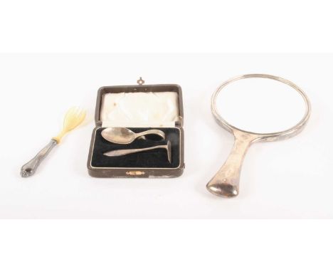 A silver backed hand mirror, Birmingham 1931, together with a silver spoon, a plated pusher and a plated fork