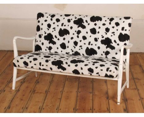 A Danish white painted and cow print upholstered two seater sofaw. 117cm