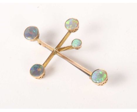 A 9 carat gold opal cabochon brooch, of abstract form, 4.3g