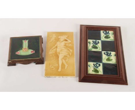 A late 19th/early 20th century yellow glazed pate-sur-pate wall tile, decorated with a lady, 30.5 x 5.5cm, together with a fr