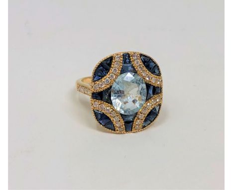 A 14ct gold aquamarine, sapphire and diamond ring, the aquamarine weighing 2.40 carats, the sapphires 2.42 carats and the dia