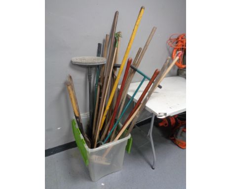 A plastic box of garden tools and brushes 