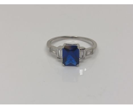 An Art Deco style Sterling silver ring set with a blue stone, size N.