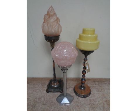 Three Art Deco table lamps with coloured glass shades  CONDITION REPORT: The yellow lamp shade has a large chip to the rim. T