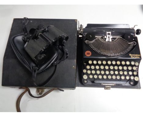 A cased Remington portable typewriter and a pair of Titan 8 x 30 field glasses