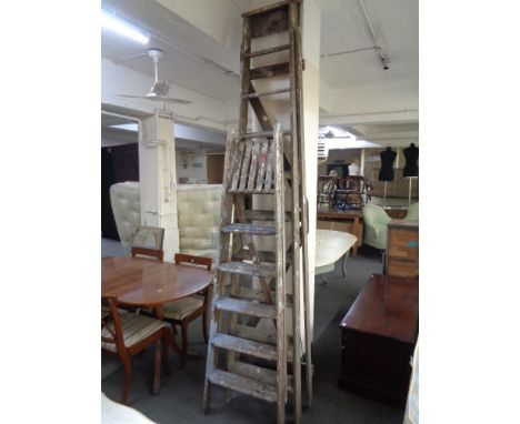 A large ten step wooden folding ladder together with a further five step ladder 