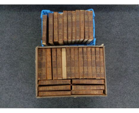 A box and a basket of thirty-two early 20th century leather bound volumes of The Encyclopedia Britannica 