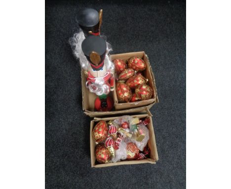 A box of two large wooden Nutcracker figures and assorted Christmas tree decorations 