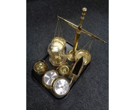 A tray of assorted brass ware, ship's style clock and barometer, balance scales, clock under shade etc 