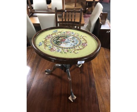 A 19th century mahogany pedestal wine table with tapestry panel top 