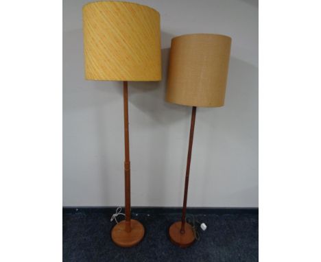 Two mid 20th century (Ercol?) teak standard lamps with shades 