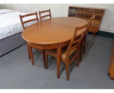 A twentieth century oval teak G-plan extending table with four ladder backed chairs 