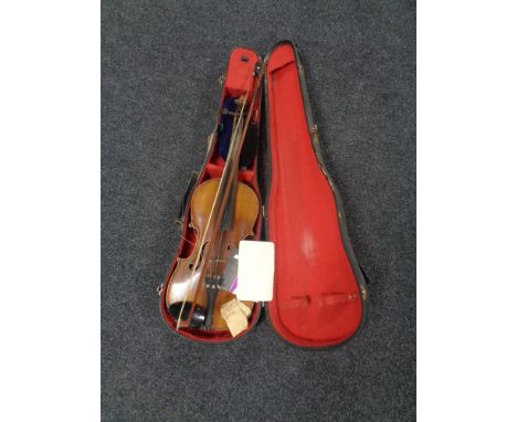 A Stradivarius copy violin with bow in fitted case  CONDITION REPORT: Back length 14". UK postage £20 plus VAT. 